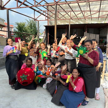 Group of people posing together with colorful toys on a rooftop.