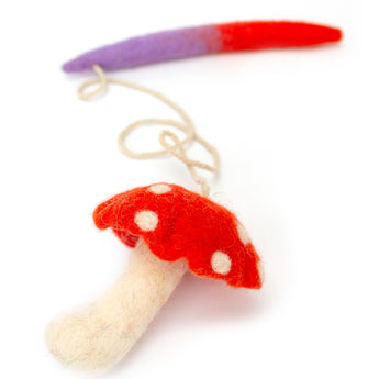 Mushroom-shaped toy with a red cap and white stem on a white background