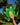 Hand holding a green frog plush toy with a blurred natural background