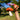 Hand holding a toy mushroom against a blurred outdoor background