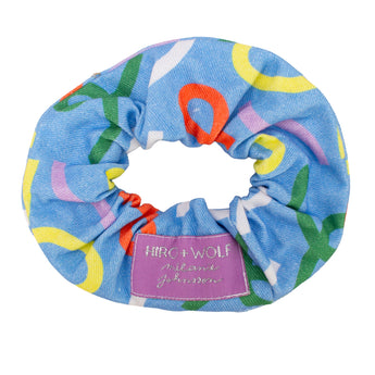Colorful scrunchie with a visible brand label on a white background