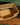 Woven dog basket with geometric pattern on a wooden floor