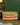 Woven dog bed pet basket with colourful stripes on a wooden floor against a green wall.