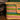 Hiro + Wolf Ghanaian hand woven dog basket with colourful stripes on a wooden floor