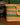 Hiro + Wolf Ghanaian hand woven dog basket with colourful stripes on a wooden floor